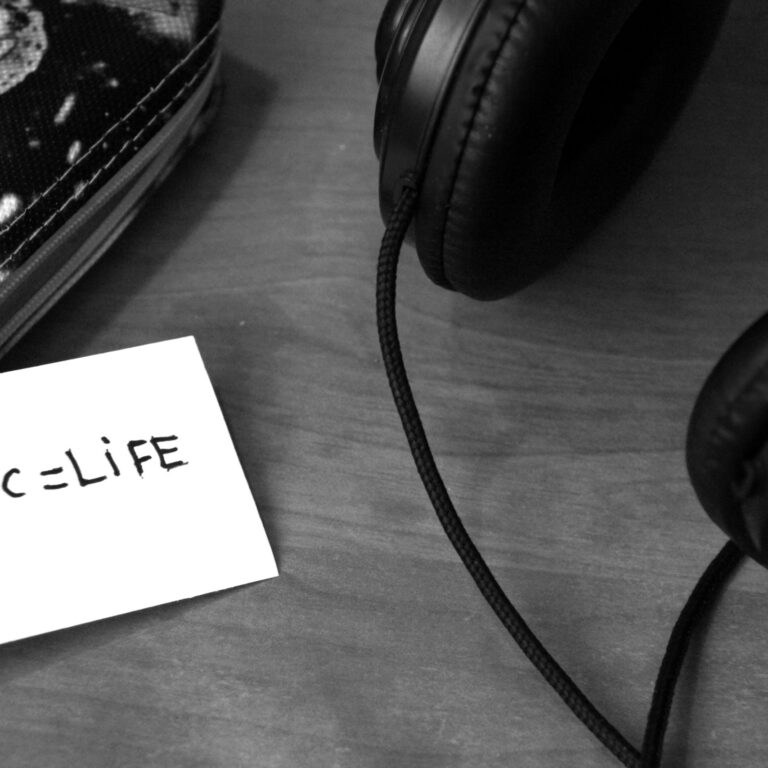 Canva – Grayscale Photo of Printer Paper With Printed Music = Life Near Headphones
